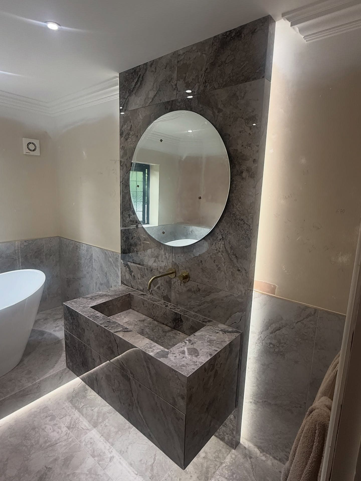 Master bathroom in Sprotbrough with raised bath and brushed brass details