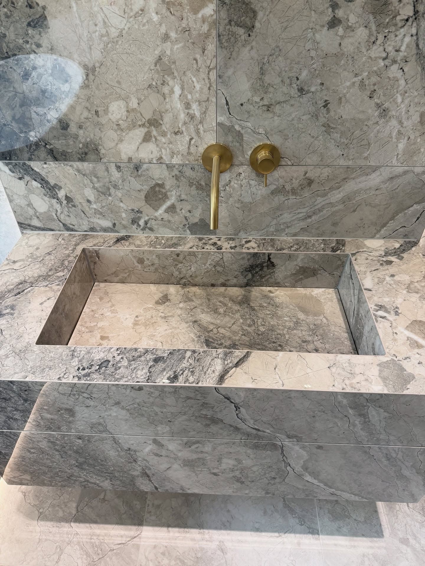 Master bathroom in Sprotbrough with raised bath and brushed brass details