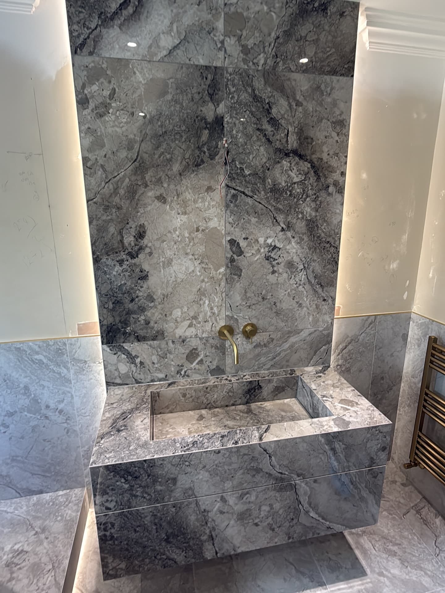 Master bathroom in Sprotbrough with raised bath and brushed brass details