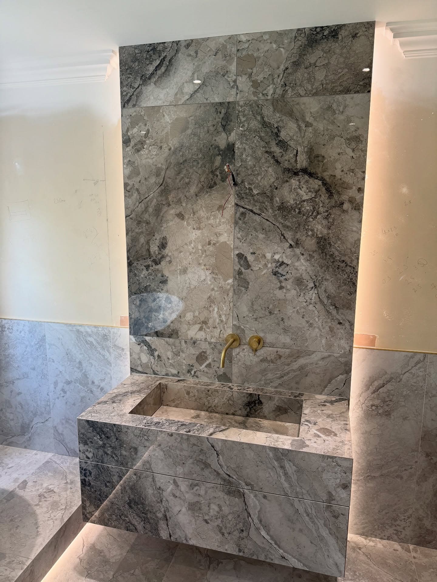 Master bathroom in Sprotbrough with raised bath and brushed brass details