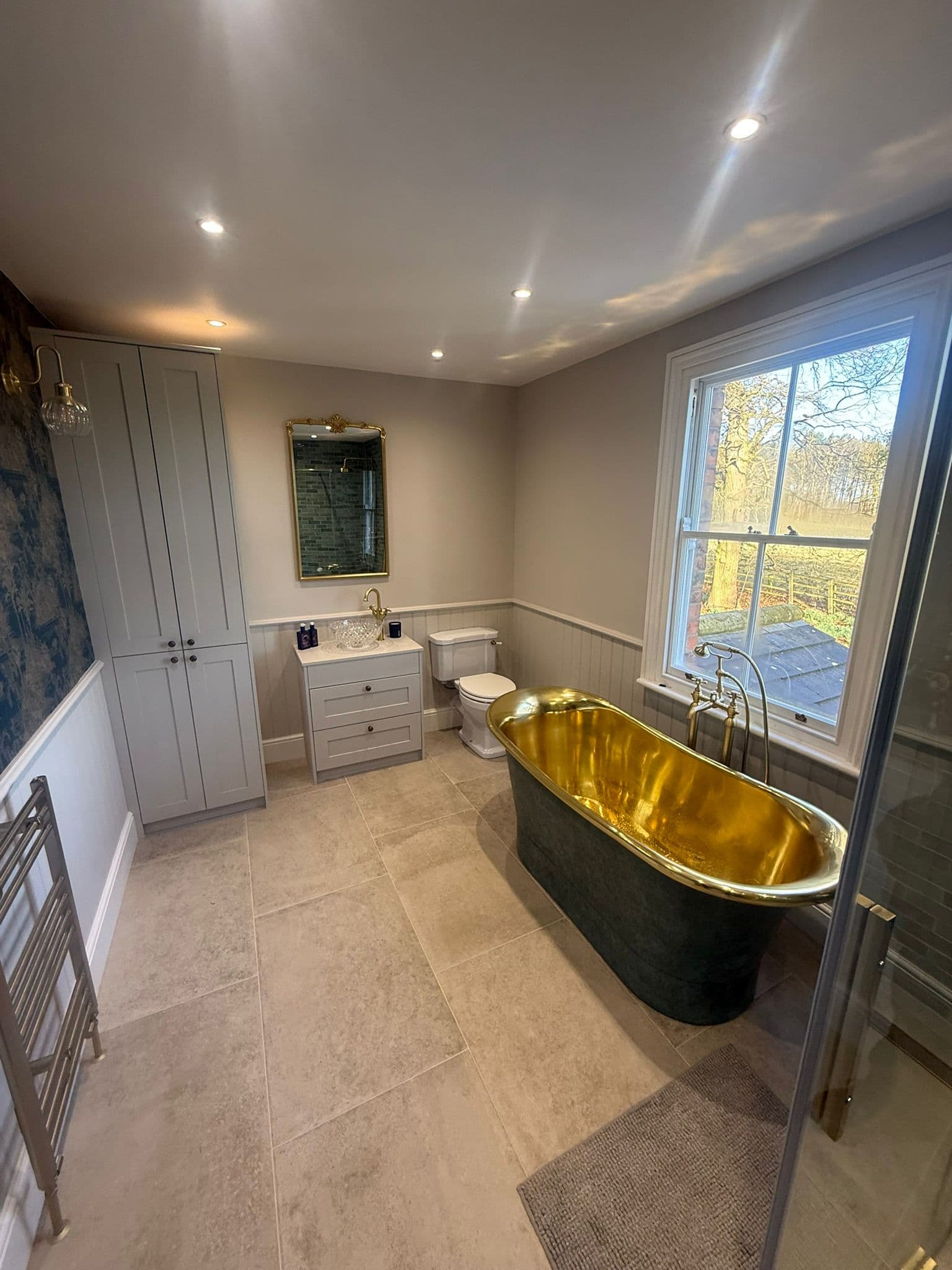 Bespoke Tiling craftsmen finishing a bathroom installation